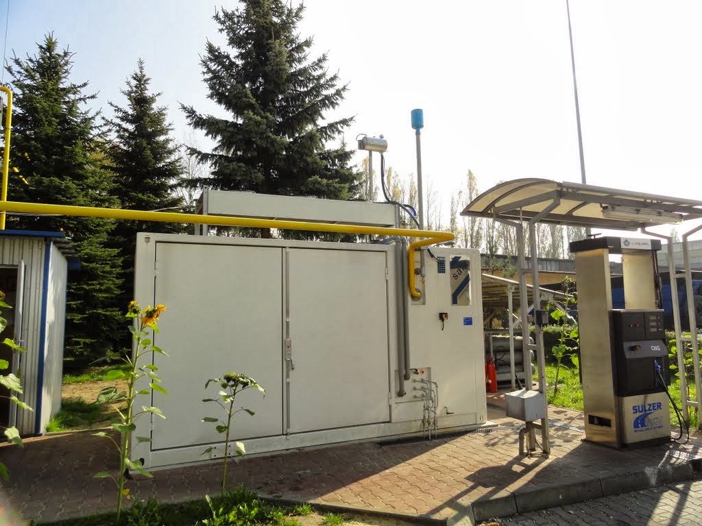 Stacja tankowania CNG z dystrybutorem Sulzer i żółtym gazociągiem nad kontenerowym budynkiem sprężarkowni